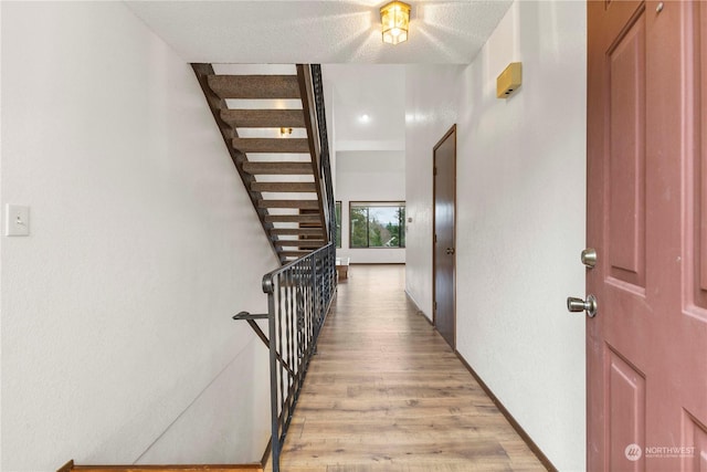 corridor with light hardwood / wood-style floors