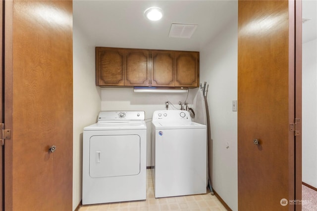 laundry area with cabinets and washing machine and clothes dryer