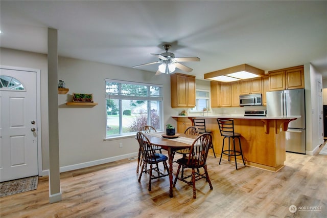 dining room featuring light wood-type flooring and ceiling fan