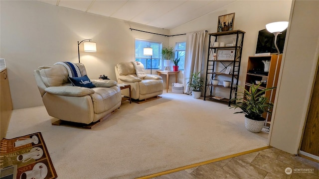 sitting room featuring carpet floors and vaulted ceiling