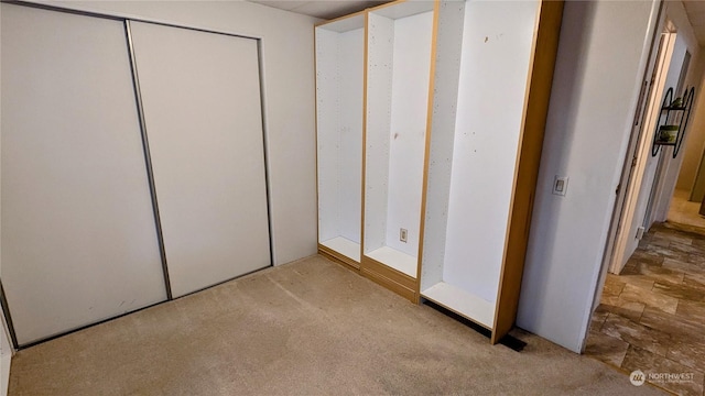 unfurnished bedroom featuring light carpet