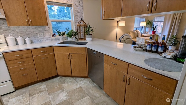 kitchen featuring dishwasher, light countertops, white electric stove, and a sink