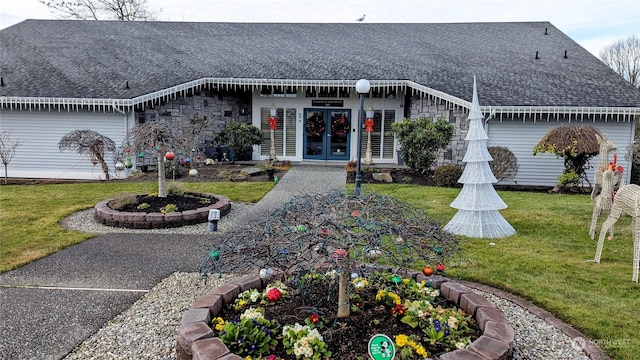 back of house featuring a lawn and french doors