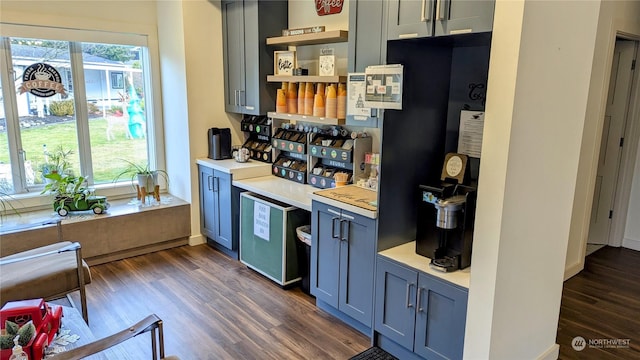 kitchen featuring dark wood-style floors, light countertops, and a healthy amount of sunlight