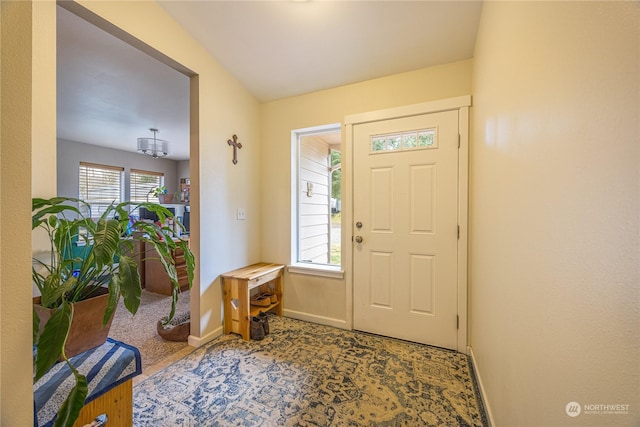 carpeted entryway with a wealth of natural light