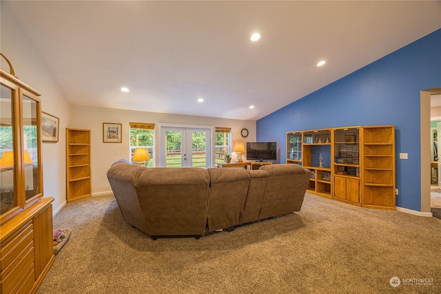 carpeted living room featuring french doors and lofted ceiling