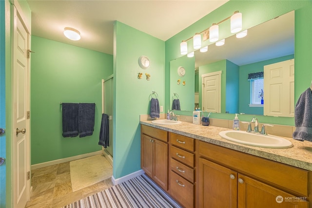 bathroom with a shower with door and vanity