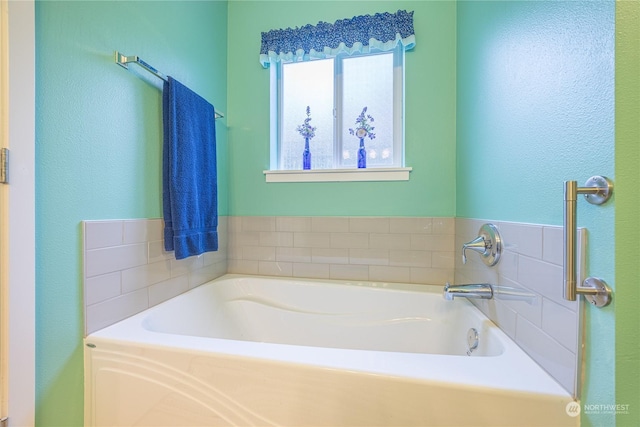 bathroom with a tub to relax in