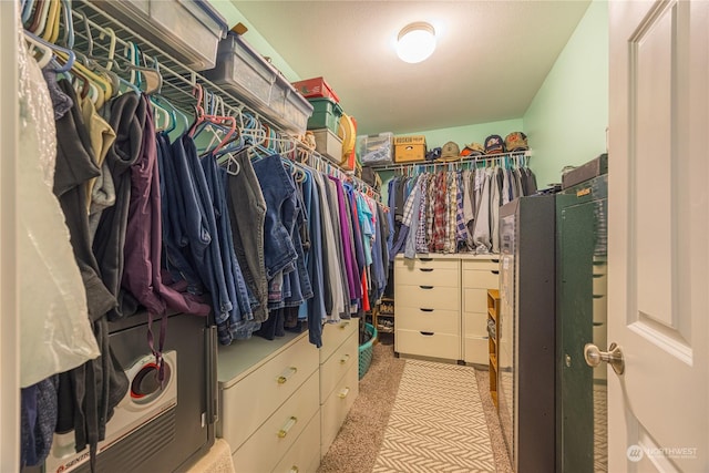 walk in closet featuring light carpet