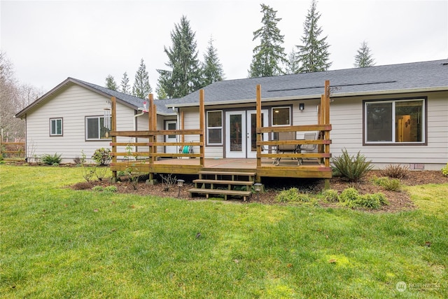 back of house featuring a lawn and a wooden deck