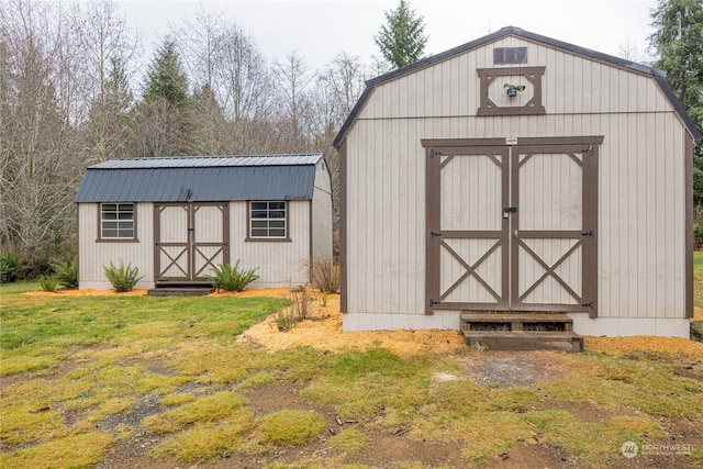 view of outbuilding featuring a lawn