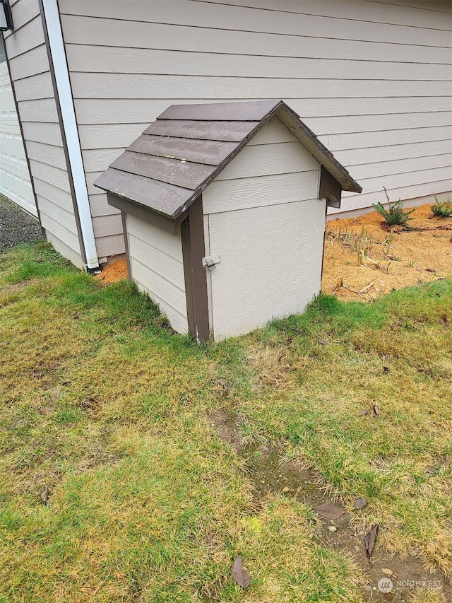 view of outdoor structure featuring a lawn