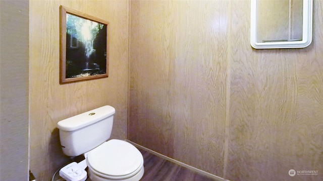 bathroom with toilet and hardwood / wood-style flooring