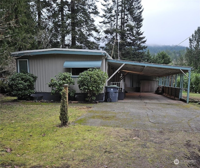 exterior space featuring a lawn and a carport