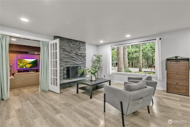 living room featuring a fireplace and light hardwood / wood-style flooring