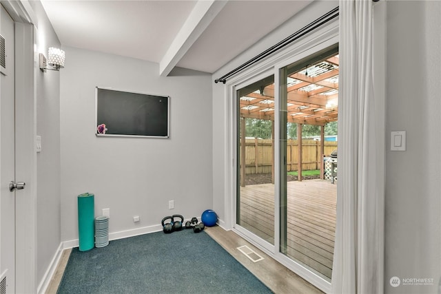 workout room featuring dark colored carpet