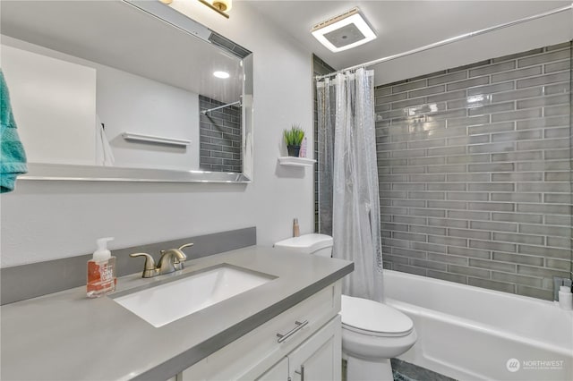 full bathroom featuring shower / bath combo with shower curtain, vanity, and toilet