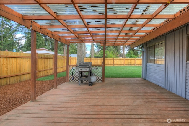 deck featuring a pergola, a lawn, and a grill