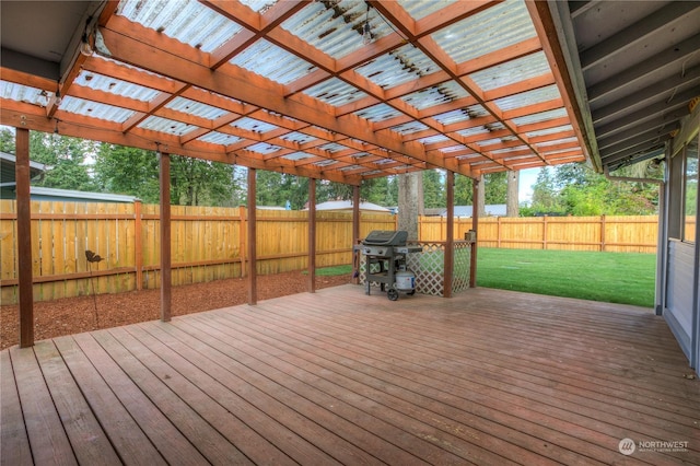 wooden terrace featuring a yard and area for grilling