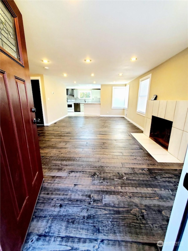 unfurnished living room featuring dark wood-type flooring