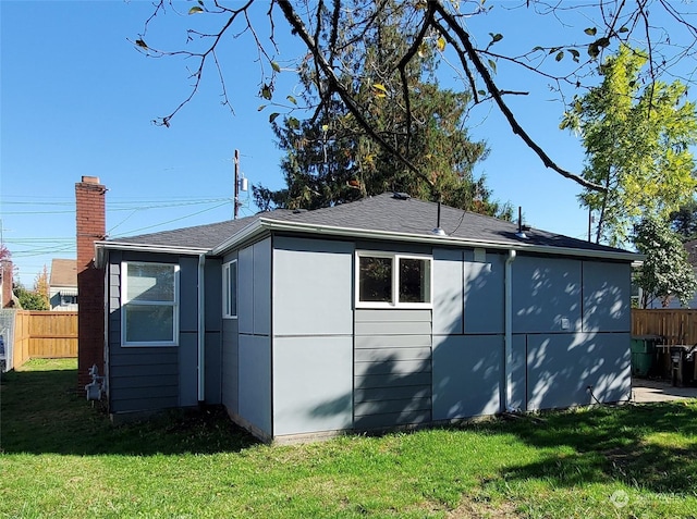 view of side of home with a yard