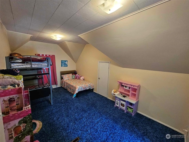 carpeted bedroom featuring baseboards and lofted ceiling