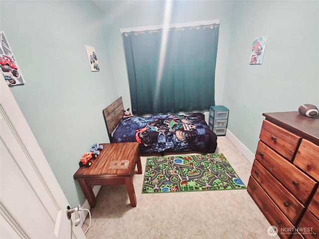 bedroom with baseboards and carpet floors