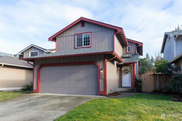 view of front property with a front yard and a garage