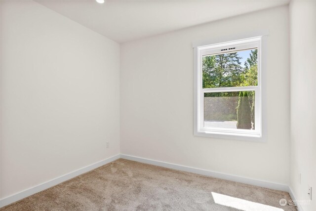 empty room featuring light colored carpet