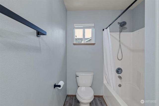 bathroom with toilet, shower / bath combo with shower curtain, and wood-type flooring