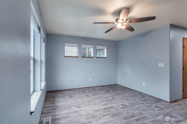 unfurnished room with ceiling fan and light hardwood / wood-style flooring