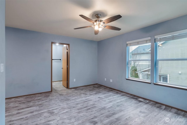 spare room with ceiling fan and light hardwood / wood-style floors