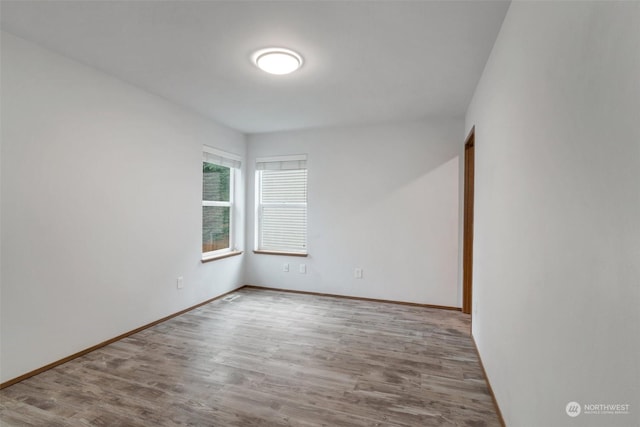 empty room featuring wood-type flooring