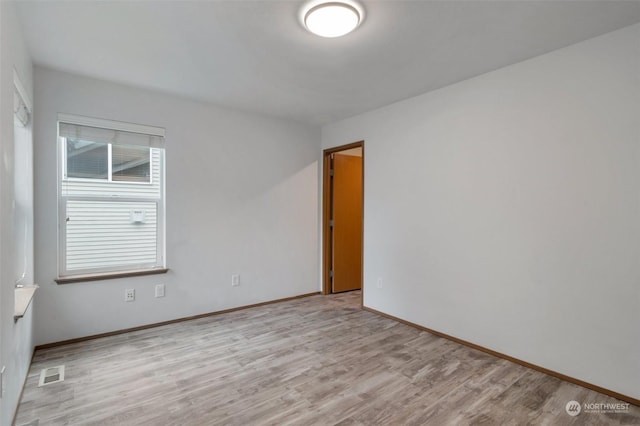 spare room with light hardwood / wood-style floors