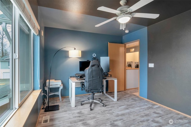 office space with separate washer and dryer, ceiling fan, and light wood-type flooring