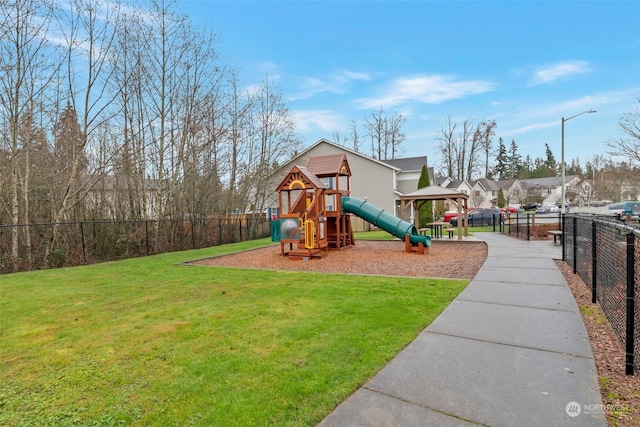 view of playground with a lawn