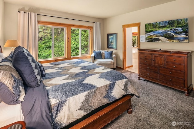 carpeted bedroom with ensuite bath