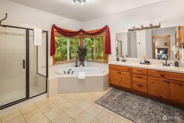 bathroom with shower with separate bathtub, vanity, and tile patterned floors