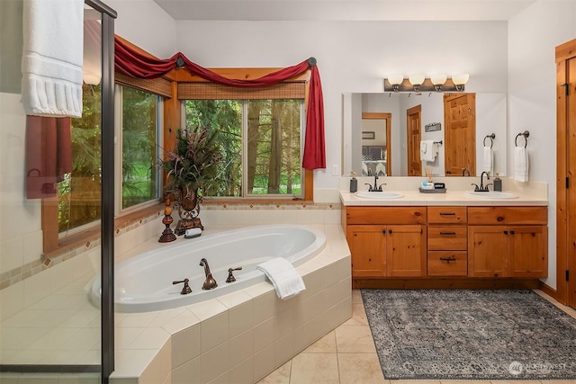 bathroom with vanity, tiled tub, and tile patterned floors