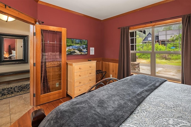 bedroom with hardwood / wood-style flooring and crown molding