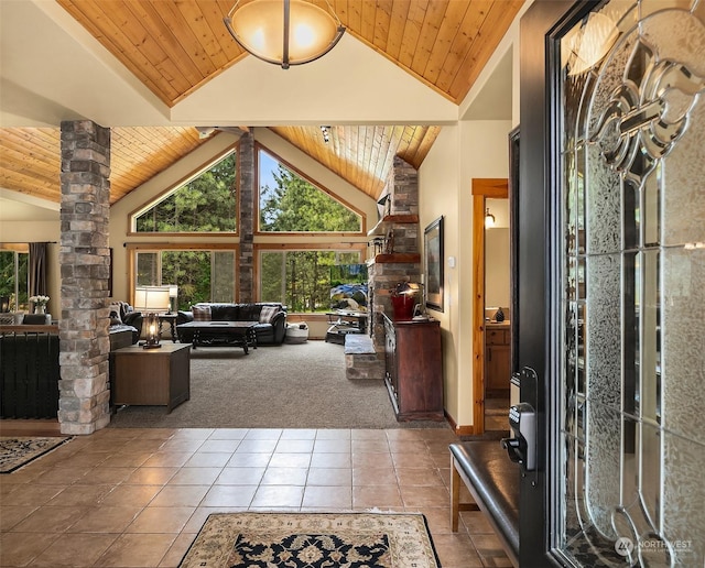 foyer entrance featuring high vaulted ceiling, wooden ceiling, decorative columns, and carpet flooring