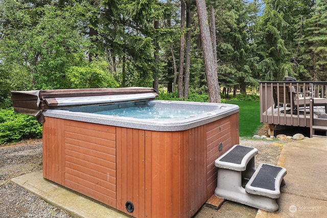 view of swimming pool with a deck and a hot tub