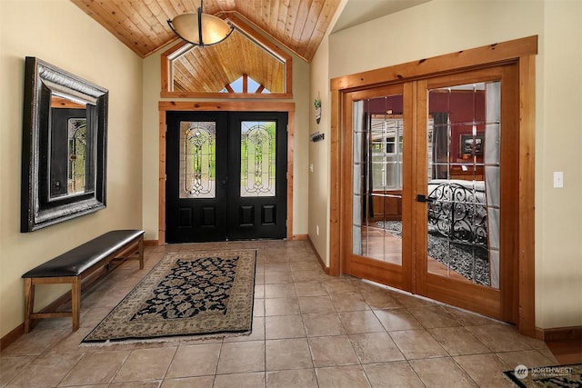 tiled entryway with french doors, wooden ceiling, and high vaulted ceiling