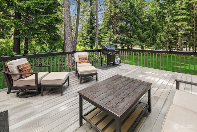 wooden terrace with area for grilling and a lawn