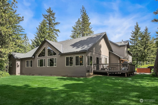 back of house with a jacuzzi, a yard, and a wooden deck