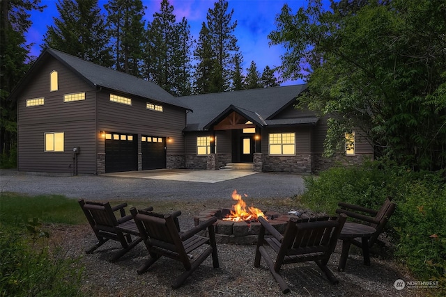 view of front of property featuring a fire pit and a garage