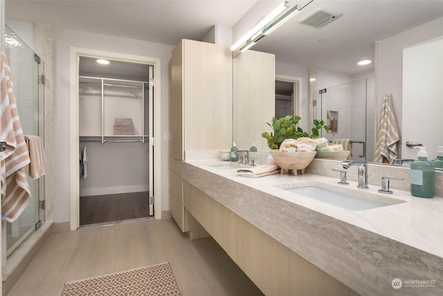 1250 Alki Ave SW Unit 3B, Seattle, WA 98116 - full bathroom with a spacious closet, double vanity, a stall shower, and recessed lighting
