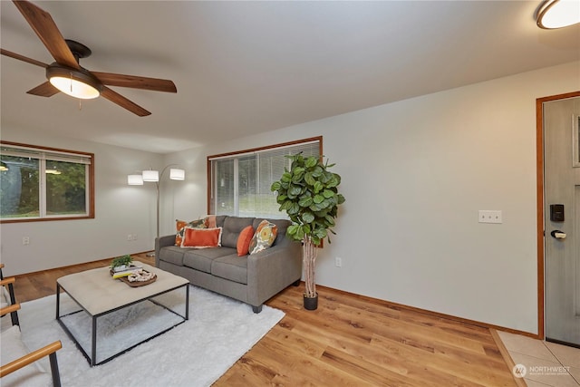 living room with light hardwood / wood-style flooring and ceiling fan