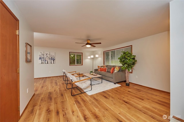 living room featuring ceiling fan and light hardwood / wood-style flooring