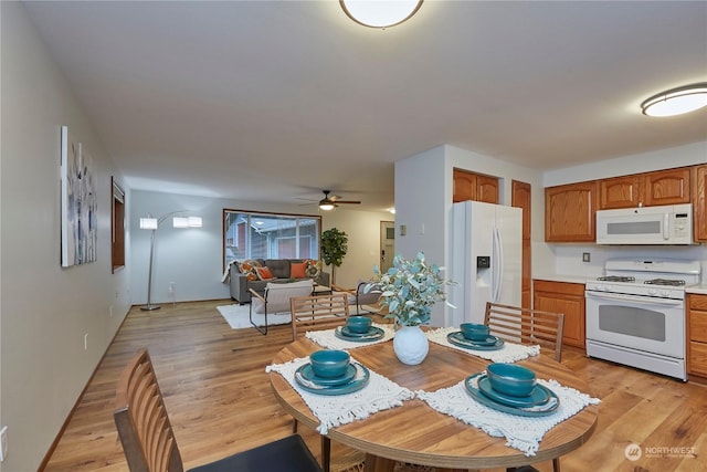 kitchen featuring white appliances, light hardwood / wood-style floors, and ceiling fan